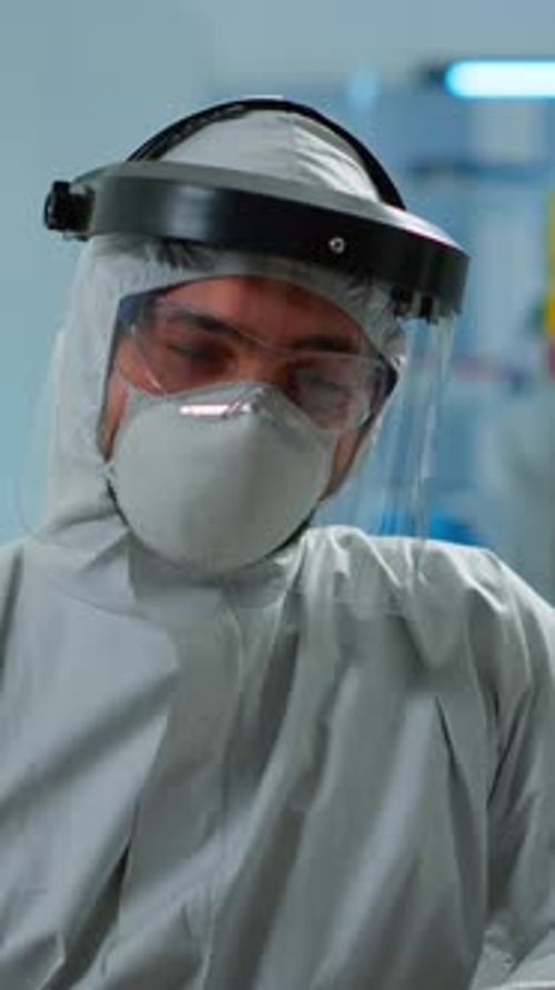 Vertical Video Close Up of Tired Chemist Man Doctor in Coverall Working in Lab