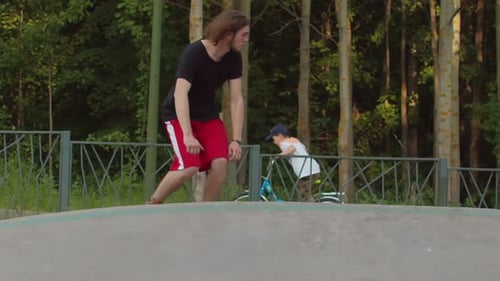 Sportive Man Skateboarding in the Park on Special Wavy Road
