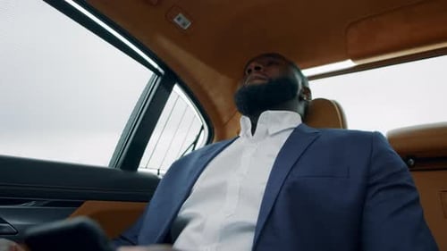 Upset man in suit sits in a car
