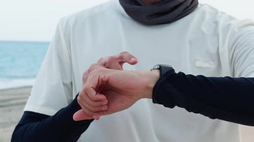 Adult Checking Pulse on Smartwatch at Beach