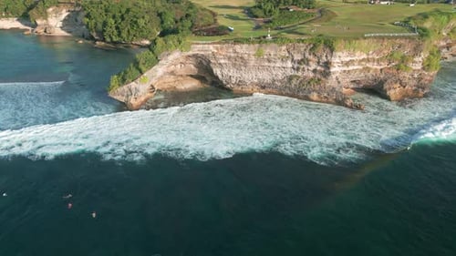 Aerial View of Balangan Beach Bali Showcasing Stunning Cliffs Surf Waves and Lush Greenery