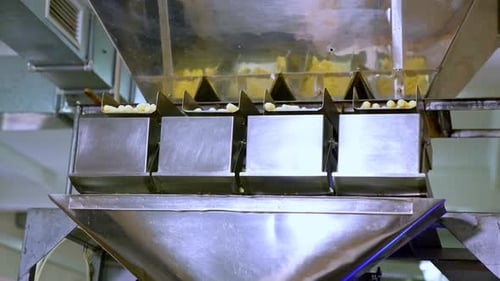 Metal automated equipment at food factory. Modern process of snack production.