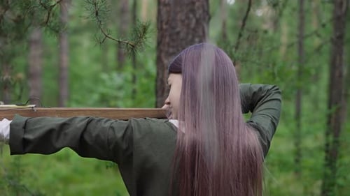 Young Girl Takes Aim to Shoot Crossbow