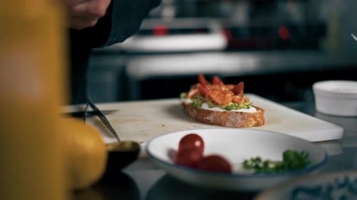 Chef Garnishing Avocado Toast Sandwich in Restaurant Kitchen