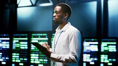 Young Adult Using Tablet in a Dark Server Room