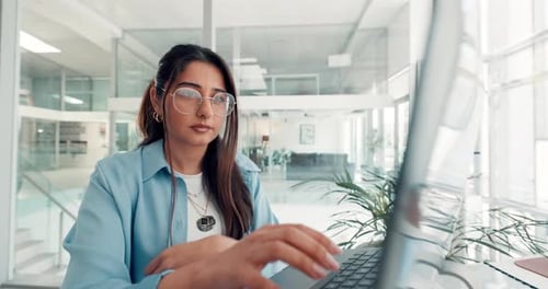 Woman Working on Laptop in Modern Office
