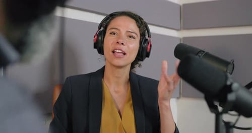 Podcasters Recording in a Studio, wearing Headphones