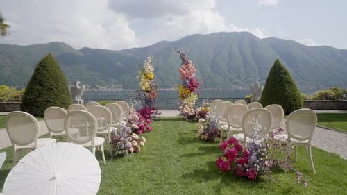 A Stunning Outdoor Wedding Setup with Beautiful Floral Arrangements and a Romantic View Action