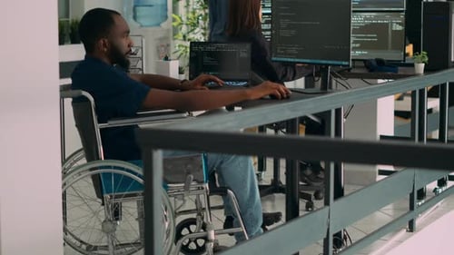 African American IT Engineer with Disability Typing Code in It Development Agency