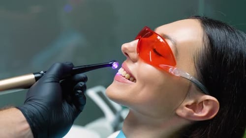 Teeth Whitening for Woman Bleaching of the Teeth at Dentist Clinic