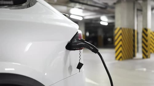 Electric Car Being Charged in Underground Parking Garage