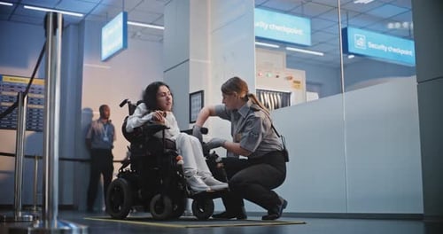 Security Checkpoint Female TSA Officer Checking Woman with Physical Disability in Airport Terminal