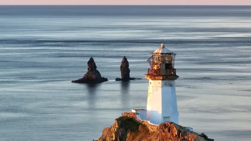 The Guiding Beacon A Majestic Lighthouse Perched on a Cliff Overlooking the Vast Ocean