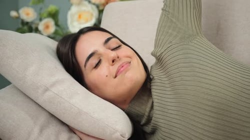Woman Resting on Couch in Home Interior