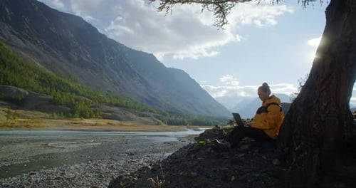 Enjoy Remote Work in Nature Using a Laptop While Surrounded By a Stunning Mountain View