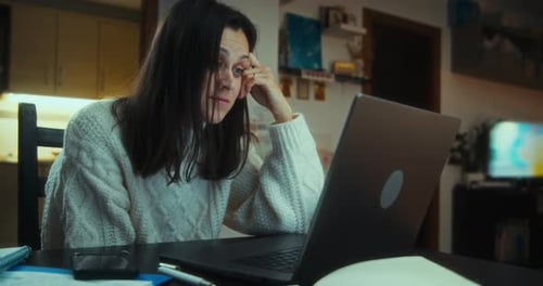 Woman Working On Laptop At Night Indoors