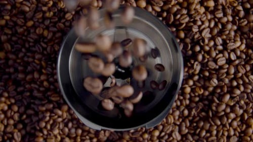 Coffee Beans Falling Into Grinder Above View