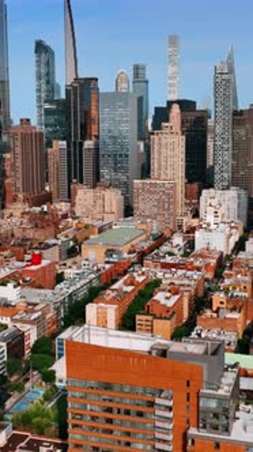 Sunny cityscape of New York from aerial view. Drone footage approaching stunning skyscrapers.