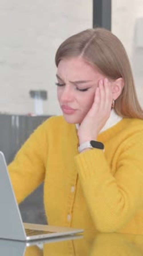 Woman with Headache Working on Laptop at Desk