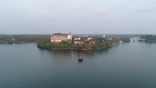 Drone footage of Lake with a hotel in the centre of the lake.