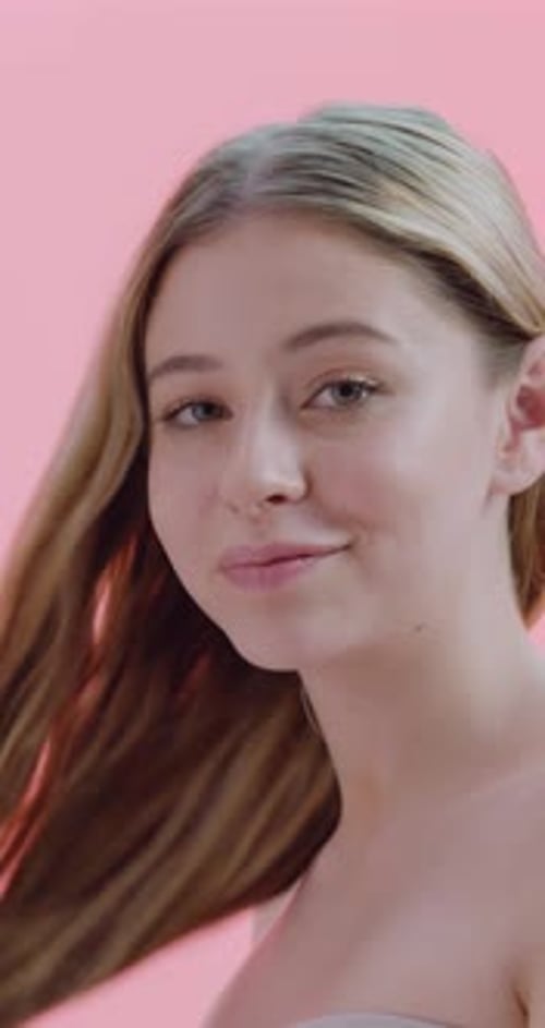 Girl, face and happy with hair care in studio, results and growth with confidence on pink