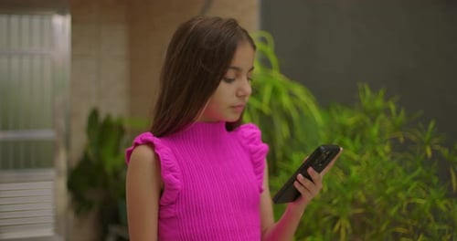 Girl Using Mobile Phone Outdoors During the Day