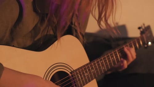 Guitarist Playing Acoustic Guitar Indoors