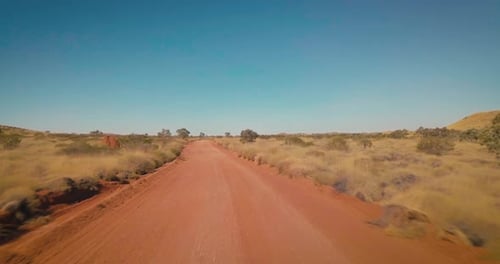 Aerial Drone flying low over vast Australian Desert down dirt road