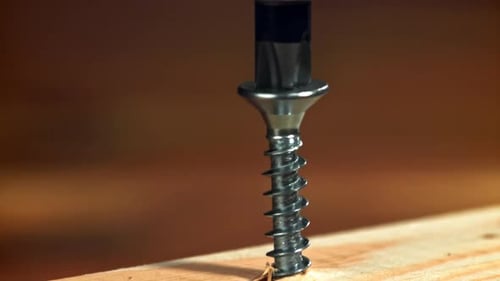 Power Drill Driving Screw into Wood Close Up