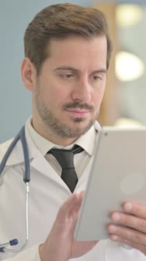 Focused Doctor Using Tablet in Medical Setting