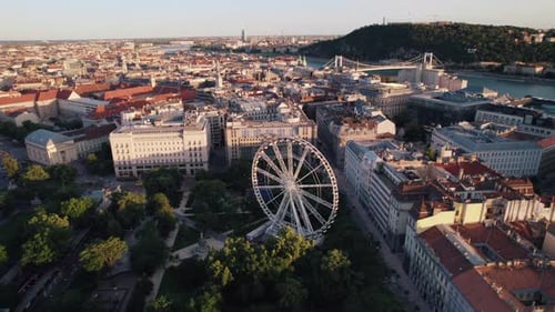 Aerial view of Budapest ferris wheel and cityscape with Danube River during sunset