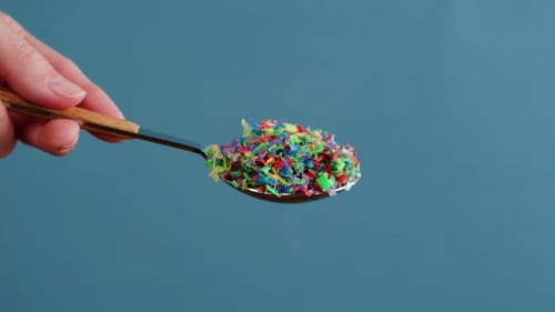 Microplastic Pollution Plastic Particles in Spoon Closeup Garbage and Trash Ecological Problems