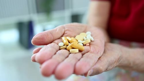 Close Up of Senior Hand Holding Medication