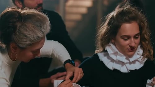 Adults Preparing Costumes in a Historical Setting