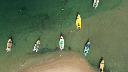 Small Fishing Boats anchored in a shallow lagoon, with packed Fish net onboard, Aerial view