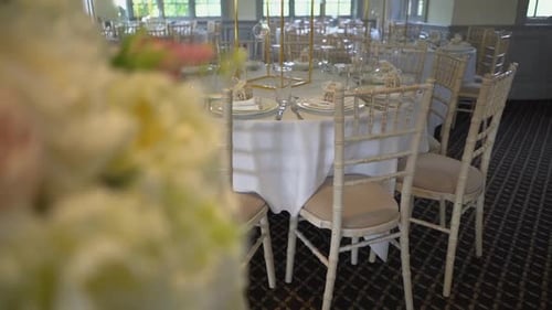 Elegant Wedding Reception Tables and Chairs with Flowers