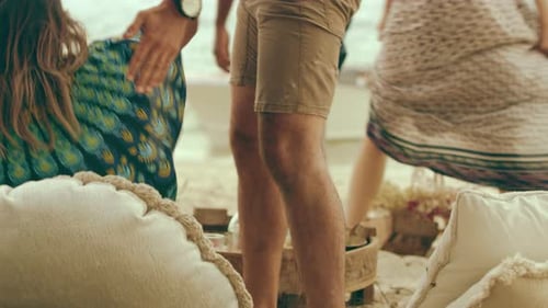 A Group of Relaxed Millennial Friends Hanging on the Beach Around A