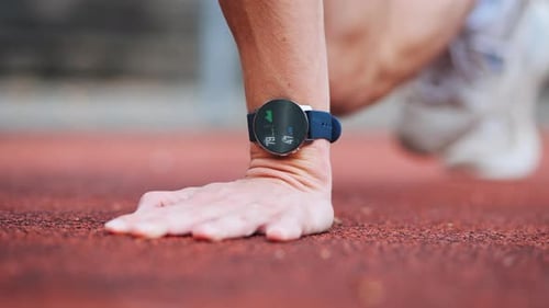 Fitness Watch Displays Data on Running Track