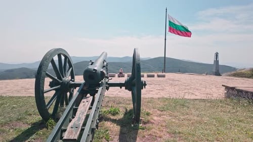 Cannon and Bulgarian Flag Waving on a Hilltop