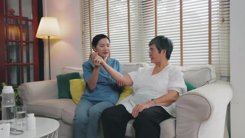 nurse provides physical therapy to the elderly at a nursing home