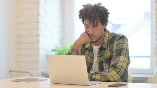Adult Using Laptop Computer at Desk Indoors