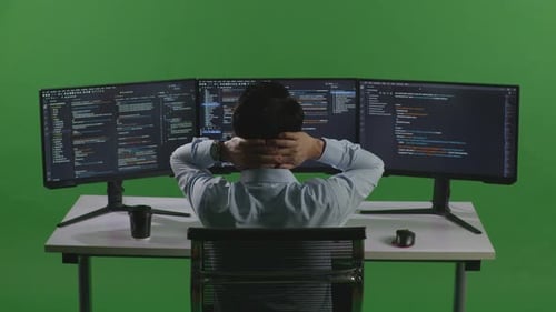 Asian Man Having Headache While Write Code With Multiple Computer Screens In Green Screen