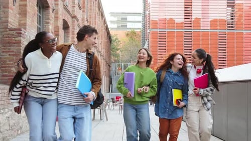 Smiling students walking together outdoors on college campus