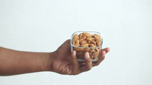 Close Up of Almond Nuts on Man's Hand