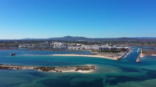 Aerial View of Fuseta Portugal Featuring the Ria Formosa Lagoon Turquoise Waters Sandy Beaches a