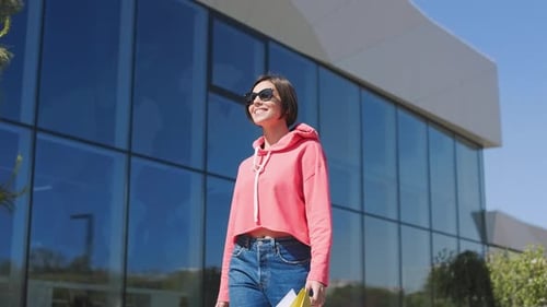 Stylish Woman Walking in City With Shopping Bags