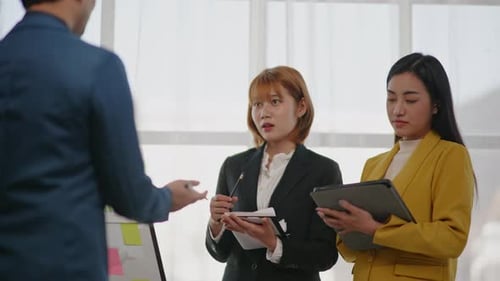 Business Team Collaborating on Project in Office