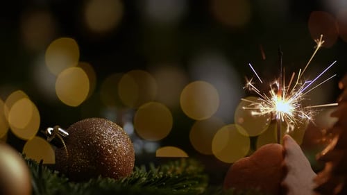 Sparkler Burning Next to Christmas Decorations