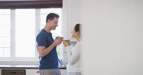 Loving Couple Talking in Bright Kitchen in Morning