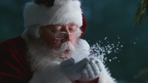 Santa Claus Blowing Snow From Hands At Christmas In Super Slow Motion.
